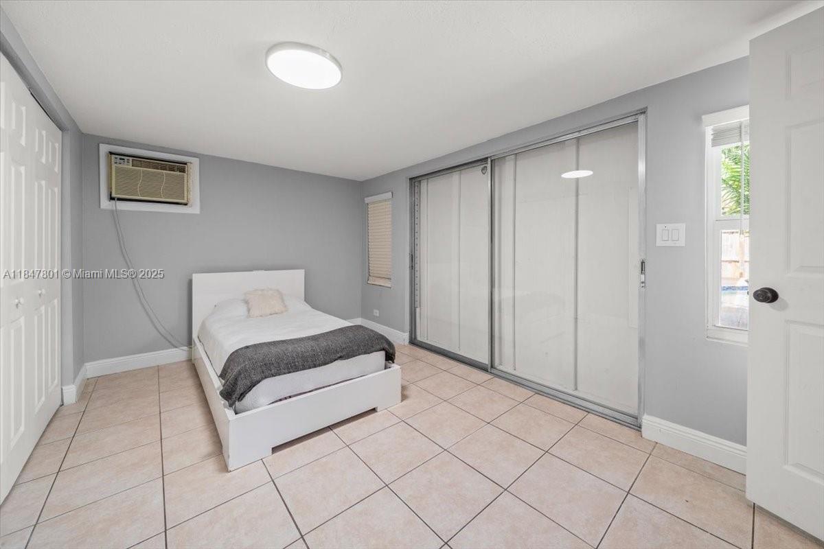 3751 Northeast 16th Avenue Pompano Beach, FL 33064 - Photo 34 of 41 a spacious bedroom with a bed and a shower