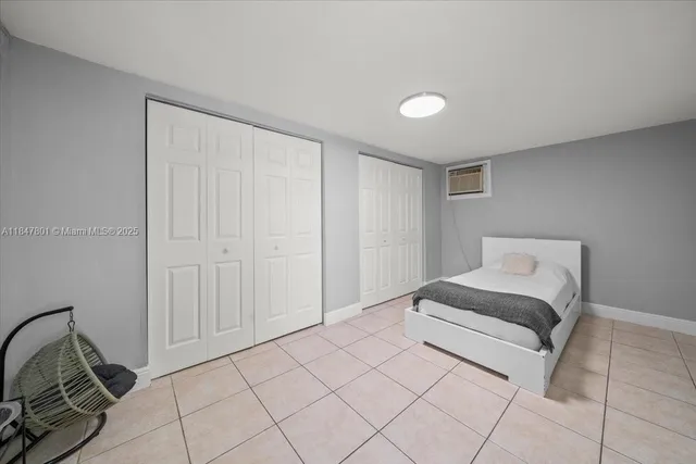 a spacious bedroom with a bed and a mirror