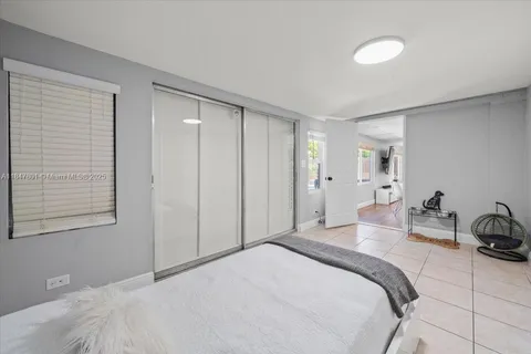 a bedroom with bed and a closet