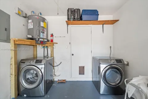 a utility room with sink dryer and washer