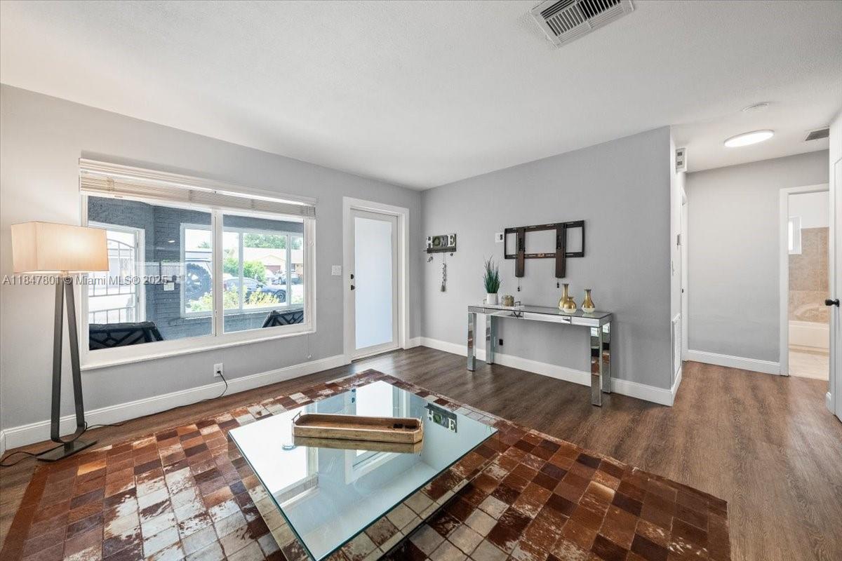 3751 Northeast 16th Avenue Pompano Beach, FL 33064 - Photo 8 of 41 a living room with furniture and a large window