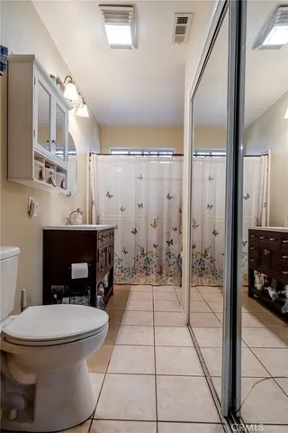 a bathroom with a toilet a sink and a mirror