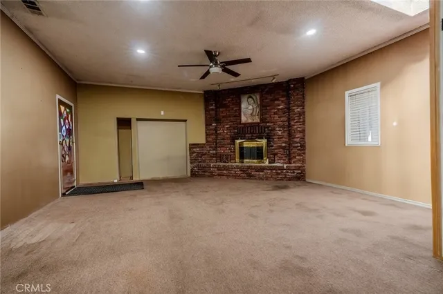an empty room with fireplace and window