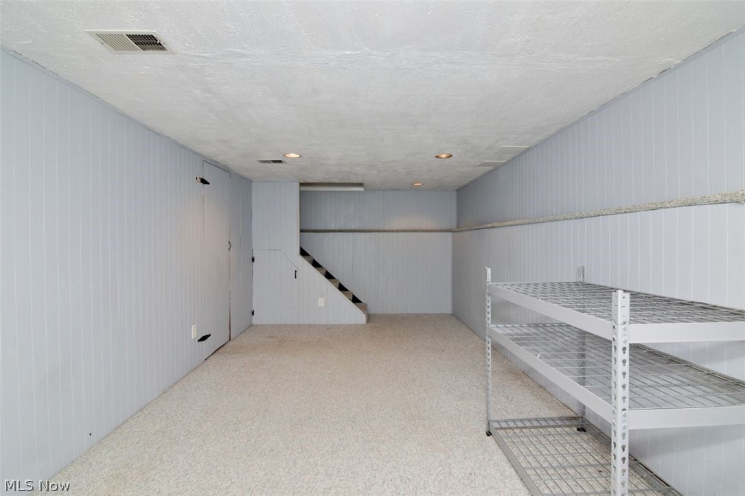 5284 Edenhurst Road Lyndhurst, OH 44124 - Photo 42 of 50 Carpeted floor, paneled walls, recessed lighting, and built-in shelving
