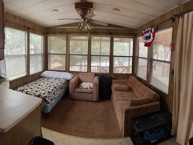 a living room with furniture and a floor to ceiling window