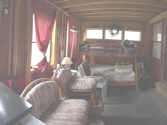 a living room with a large window and furniture