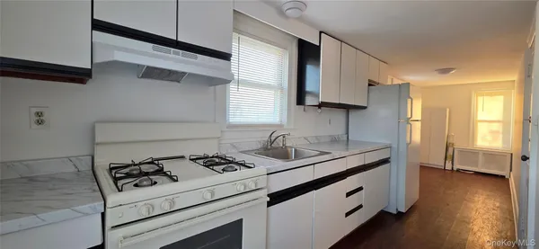 a kitchen with stainless steel appliances cabinets a sink and a stove