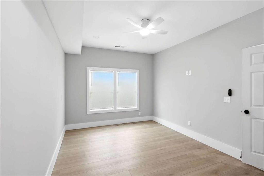 159 Brad Street Royston, GA 30662 - Photo 11 of 21 an empty room with wooden floor and windows