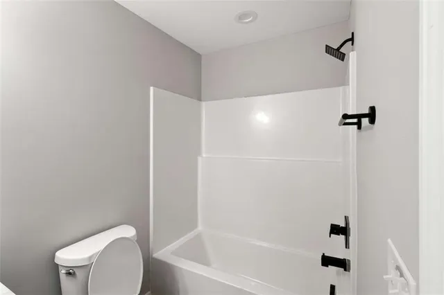 a bathroom with a toilet and a tub