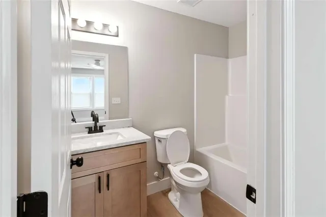 a bathroom with a toilet a sink and mirror