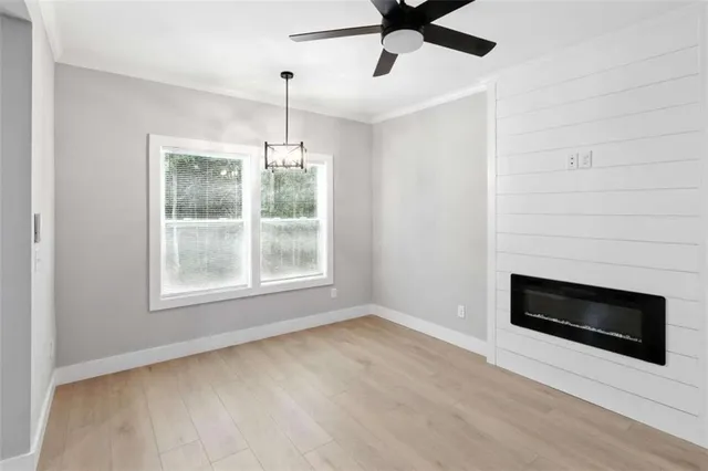a view of an empty room with a fireplace and a window