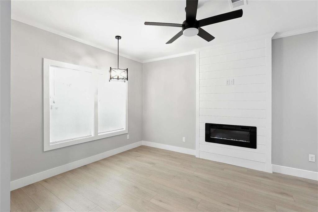 159 Brad Street Royston, GA 30662 - Photo 4 of 21 a view of an empty room with a window and kitchen view