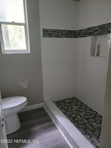 a bathroom with a toilet and a shower