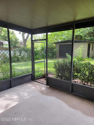 a view of a yard with porch and garden
