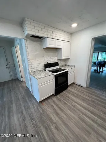 a kitchen with stainless steel appliances granite countertop a stove and a sink
