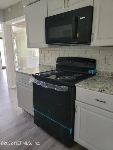 a kitchen with a stove and a microwave