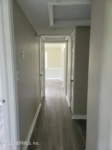 a view of hallway with wooden floor