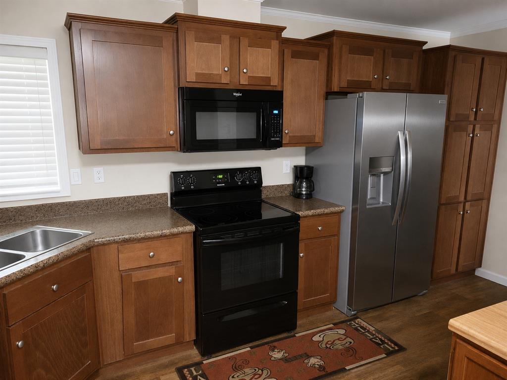 2900 Interstate 35, Unit 80 Waco, TX 76706 - Photo 2 of 10 a kitchen with a refrigerator sink and microwave