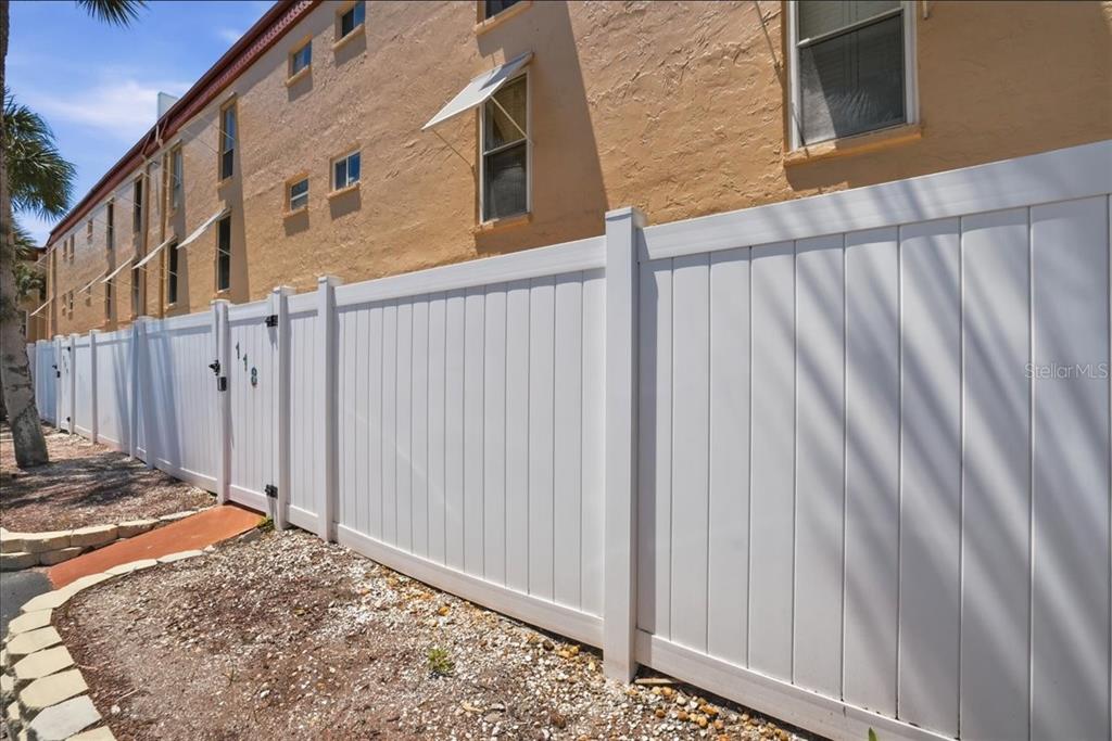 8911 Blind Pass Road, Unit 118 St. Pete Beach, FL 33706 - Photo 33 of 34 a view of a house with a backyard