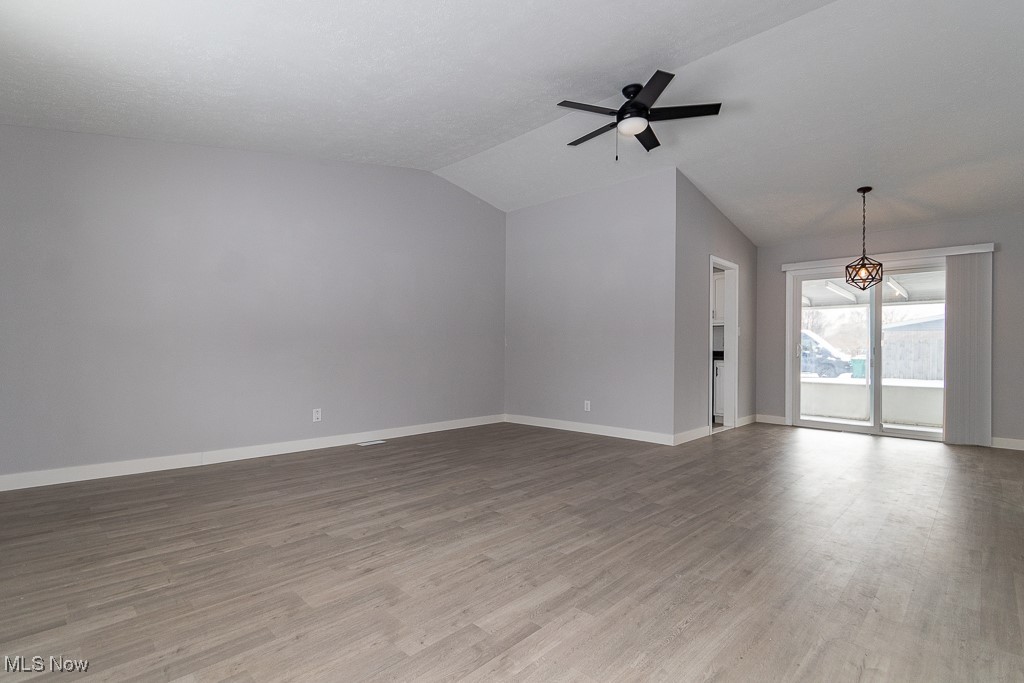 7996 Munson Road Mentor, OH 44060 - Photo 3 of 33 Unfurnished living room with lofted ceiling, hardwood / wood-style flooring, and ceiling fan