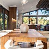 a kitchen with a table chairs and wooden floor
