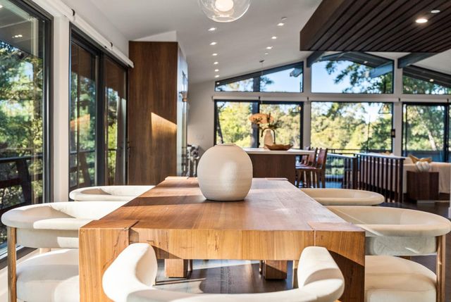 a kitchen with a table chairs and wooden floor
