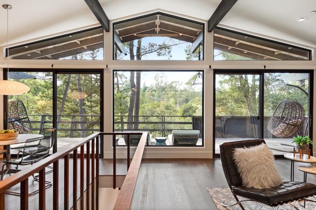 a kitchen with stainless steel appliances granite countertop a refrigerator a sink a dining table and chairs