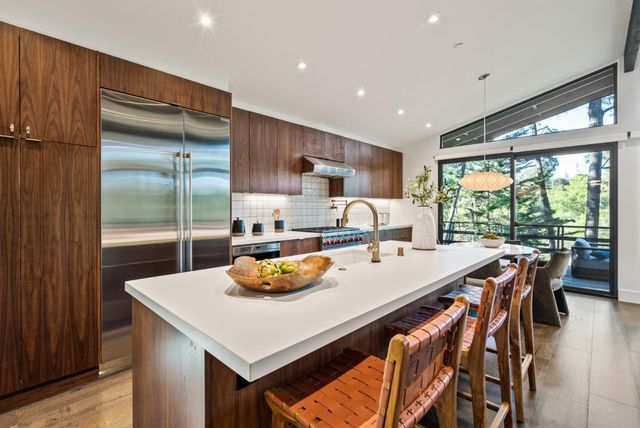 a kitchen that has a table and chairs in it