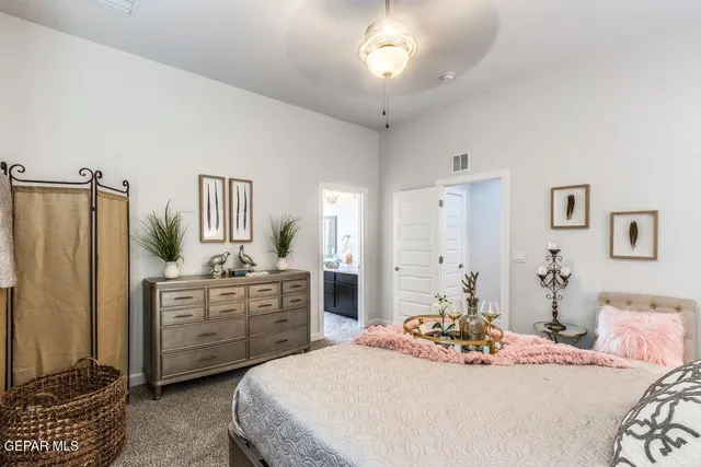 a bedroom with a bed and dresser with mirror