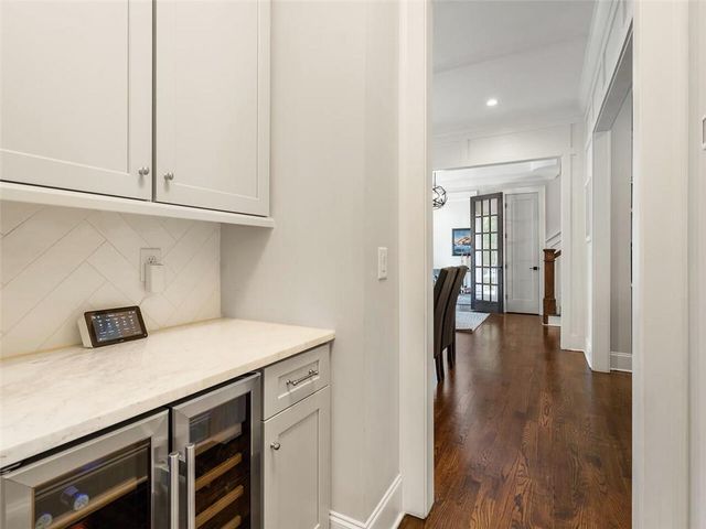 a living room with furniture a piano and a large window