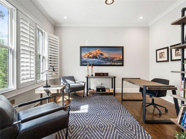 a bedroom with a bed and a wooden floor