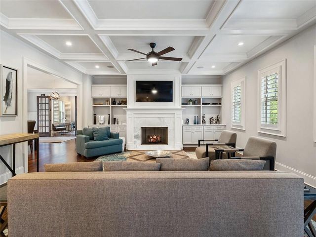 a living room with fireplace furniture and a flat screen tv