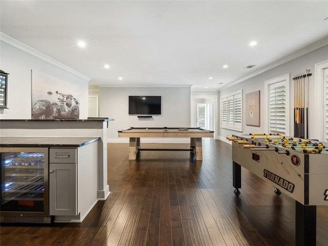 a bathroom with a toilet a sink a mirror and a bathtub
