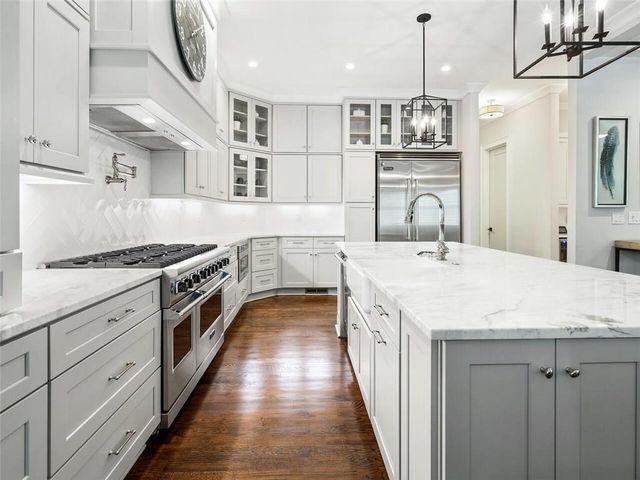 a large kitchen with a stove and a sink