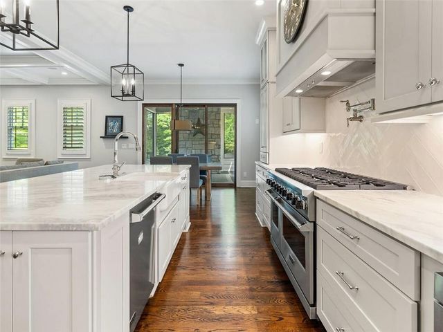 a kitchen with a table chairs and wooden floor