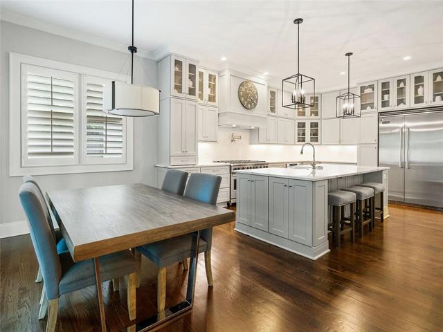a living room with a fireplace and large windows