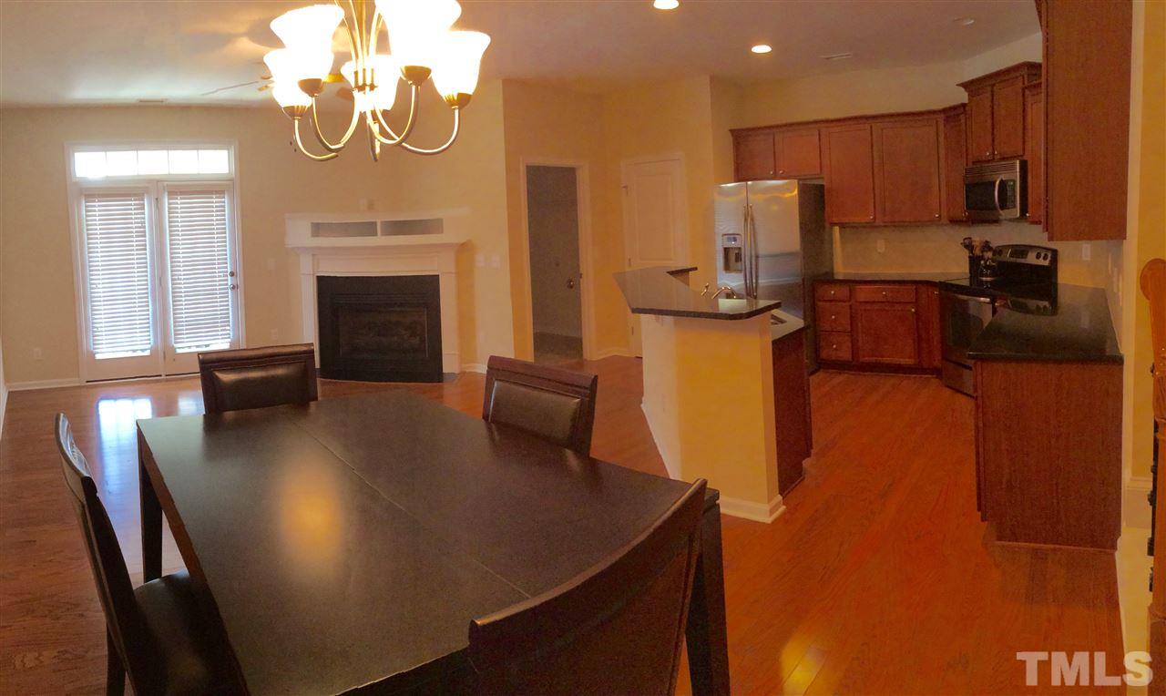 512 Dragby Lane Raleigh, NC 27603 - Photo 21 of 21 Open floor plan with beautiful eat-in kitchen, family room with fire place and built-ins for media.