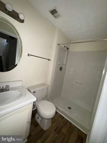 a bathroom with a toilet a sink and shower