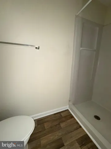 a bathroom with a toilet and a shower