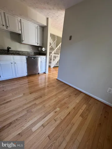 a view of kitchen with wooden floor and electronic appliances