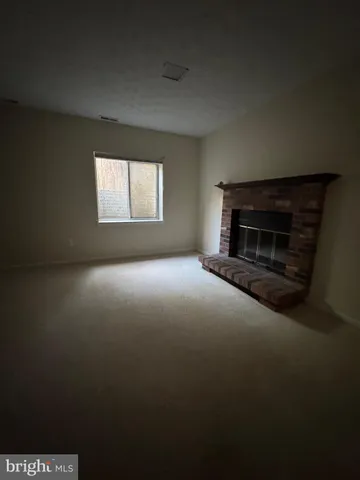 a view of empty room with a fireplace