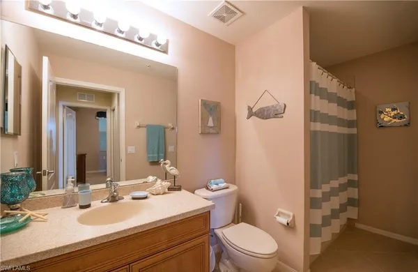 a bathroom with a sink vanity mirror and toilet