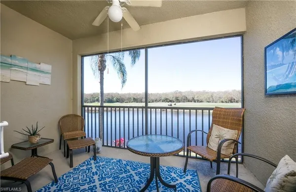 a balcony with wooden floor and a potted plant