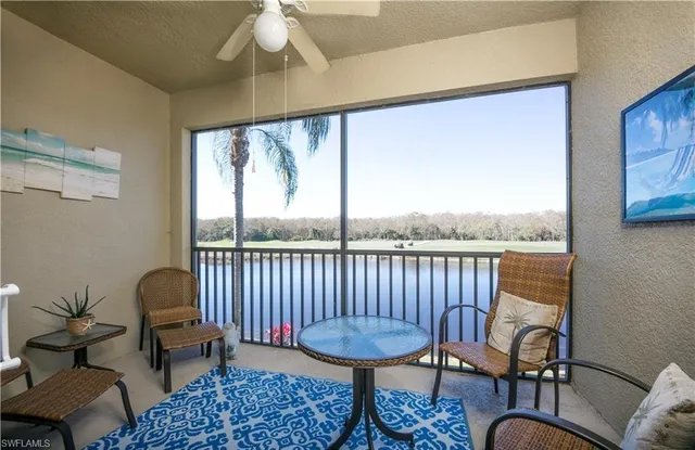 a balcony with wooden floor and a potted plant
