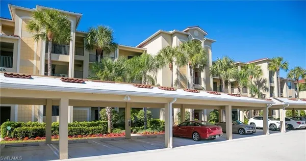 a view of a building with a porch and furniture