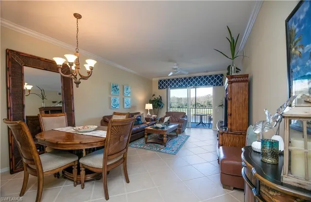 a living room with furniture a window and a chandelier