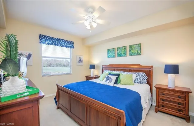 a bedroom with a bed chandelier and a window