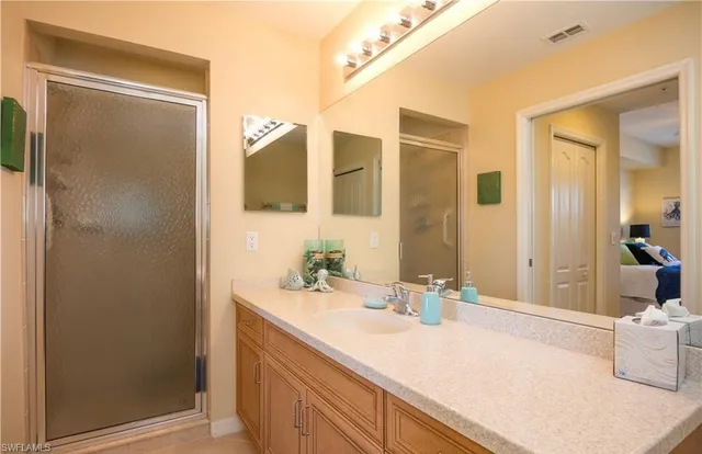 a bathroom with a granite countertop sink and a mirror
