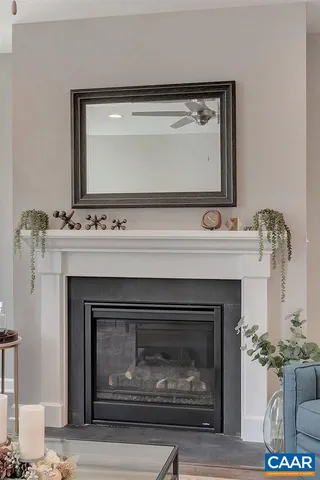 a kitchen with a dining table chairs refrigerator and white cabinets