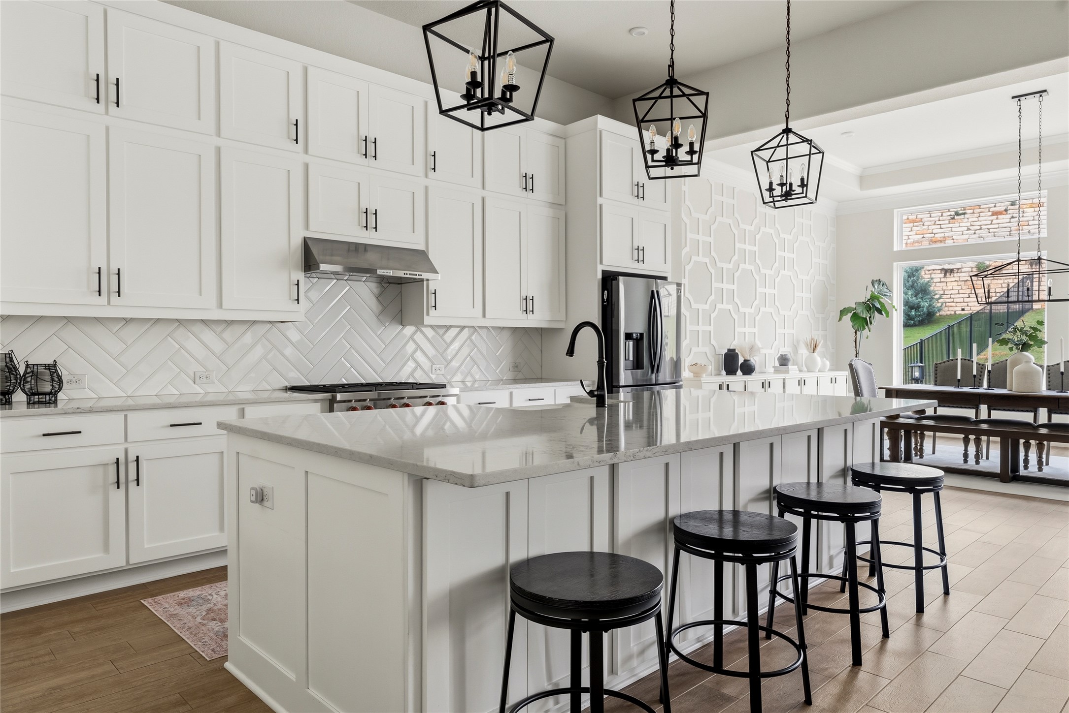 4513 Vieste View Leander, TX 78641 - Photo 11 of 40 Expansive kitchen island with a light-toned countertop, flanked by bright white cabinetry featuring black hardware